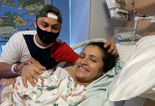 Elsa in hospital bed with newly born Sofia and husband Victor at their side