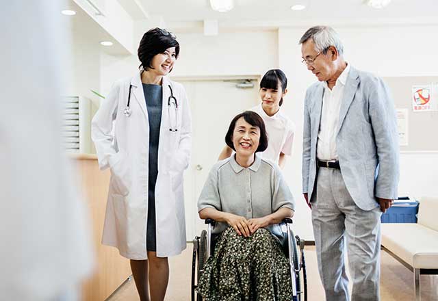 Woman checking out of hospital in wheelchair